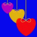 Three varicoloured fluffy hearts on a blue background
