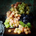 Three varieties of fresh ripe grapes on a gray background. Harvest. Fresh summer fruits. Royalty Free Stock Photo