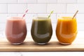 Three Varieties of Healthy Smoothies on a Kitchen Cabinet