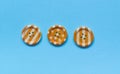 Three Various orange sewing buttons on blue background Royalty Free Stock Photo