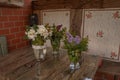 Vases with wildflowers on a glass table