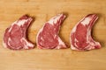 Three veal steaks on a wooden kitchen board Royalty Free Stock Photo