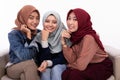 Three veiled women sitting on the couch while look at camera Royalty Free Stock Photo