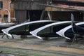 Three venetian gondolas in a dockyard