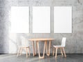 Three Vertical Posters Mockup with Two wooden chairs and table in empty room Royalty Free Stock Photo