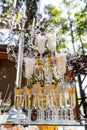 Three vertical raw of full glasses of champagne. Candelstick with pearl threads. Selective focus.