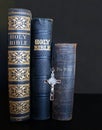 Three antique Bibles with crucifix lined up Royalty Free Stock Photo