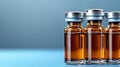 Three vials of medicine sitting on a blue surface Royalty Free Stock Photo