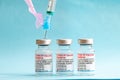 Three vials of Moderna vaccine with a syringe for coronavirus treatment