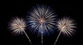 Three Bright Fireworks Exploding in a Dark Night Sky with Streaking Light Trails Royalty Free Stock Photo