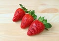 Three Vibrant Red Color Fresh Ripe Strawberry Fruits