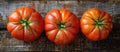 Three Vibrant Tomatoes on Wooden Table Royalty Free Stock Photo