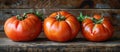 Three Vibrant Tomatoes on Wooden Table Royalty Free Stock Photo