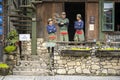 Three Vietnamese waiters are standing next to the restaurant and waiting for customers in mountain village Sapa, North Vietnam