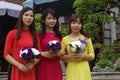 Three vietnamese young women with flowers