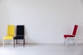 Three old vintage chairs in the interior of an empty white room Royalty Free Stock Photo