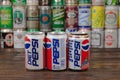 A row of vintage Pepsi aluminium cans with the cans background located on the wooden table. Pepsi is a one of the most popular