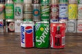 A row of vintage Pepsi, Sprite, Coca-Cola aluminium cans with the cans background located on the wooden table