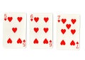 Three vintage playing cards showing a run of hearts.