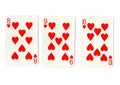 Three vintage playing cards showing a run of hearts.