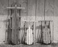Three vintage sleds in sepia color