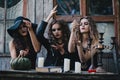 Three vintage witches perform magic ritual Royalty Free Stock Photo