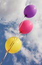 Three vivid color balloons on blue sky background