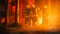 Three Volunteer Firefighters with Safety Equipment and Uniform Encircle a Raging Forest Fire Before Royalty Free Stock Photo