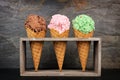 Three waffle cones of ice cream in rustic holder over slate Royalty Free Stock Photo