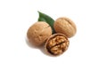 Three walnuts and a green leaf on a white isolate background Royalty Free Stock Photo