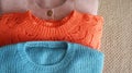 Three warm sweaters close-up. Women\'s stylish autumn or winter clothes. Cozy Winter look. Flat lay, top view Royalty Free Stock Photo