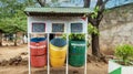 Three waste recycling bins outdoors