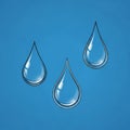Three water droplets falling against a clear blue sky background Royalty Free Stock Photo