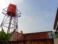 Three water tanks on rooftops under a clear blue sky. Royalty Free Stock Photo
