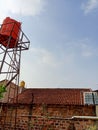 Three water tanks on rooftops under a clear blue sky. Royalty Free Stock Photo