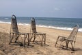 Three wattled chairs stand on a beach, wait for people against the sea. GOA India beach Royalty Free Stock Photo