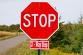 Three Way Stop Sign on a country road with trees during summer Royalty Free Stock Photo