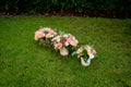 Three wedding bouquets on the green grass.