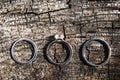 Three wedding rings on a wooden background