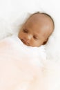 Three weeks old baby sleeping on white blanket cute infant newborn lying down close up shot eyes closed Royalty Free Stock Photo