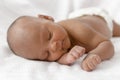 Three weeks old baby sleeping on white blanket cute infant newborn lying down close up shot eyes closed Royalty Free Stock Photo