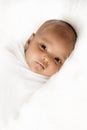 Three weeks old baby sleeping on white blanket cute infant newborn lying down close up shot eyes open