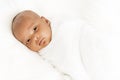 Three weeks old baby sleeping on white blanket cute infant newborn lying down close up shot eyes open Royalty Free Stock Photo