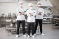 Three well-dressed chefs standing together in the professional kitchen Royalty Free Stock Photo