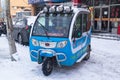 Three-wheel motor scooter with a cab on the streets of Hunchun in China