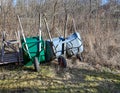 three wheelbarrows standing in a back garden