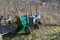 three wheelbarrows standing in a back garden