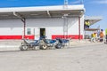 Three wheelbarrows with tools for cleaning are lined up