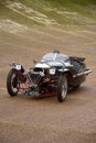 Three wheeled Morgan Super Sport car on the curved banking of Brooklands racetrack. Surrey, England. Royalty Free Stock Photo