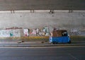 three-wheeled motorcycle under the bridge